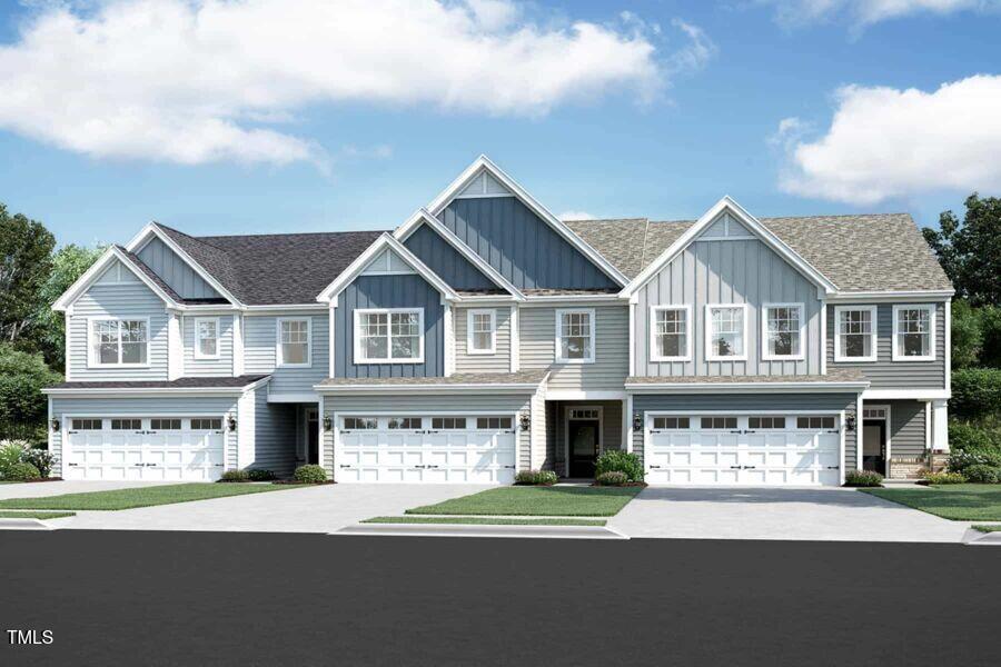 a front view of residential houses with yard and mountain view in back