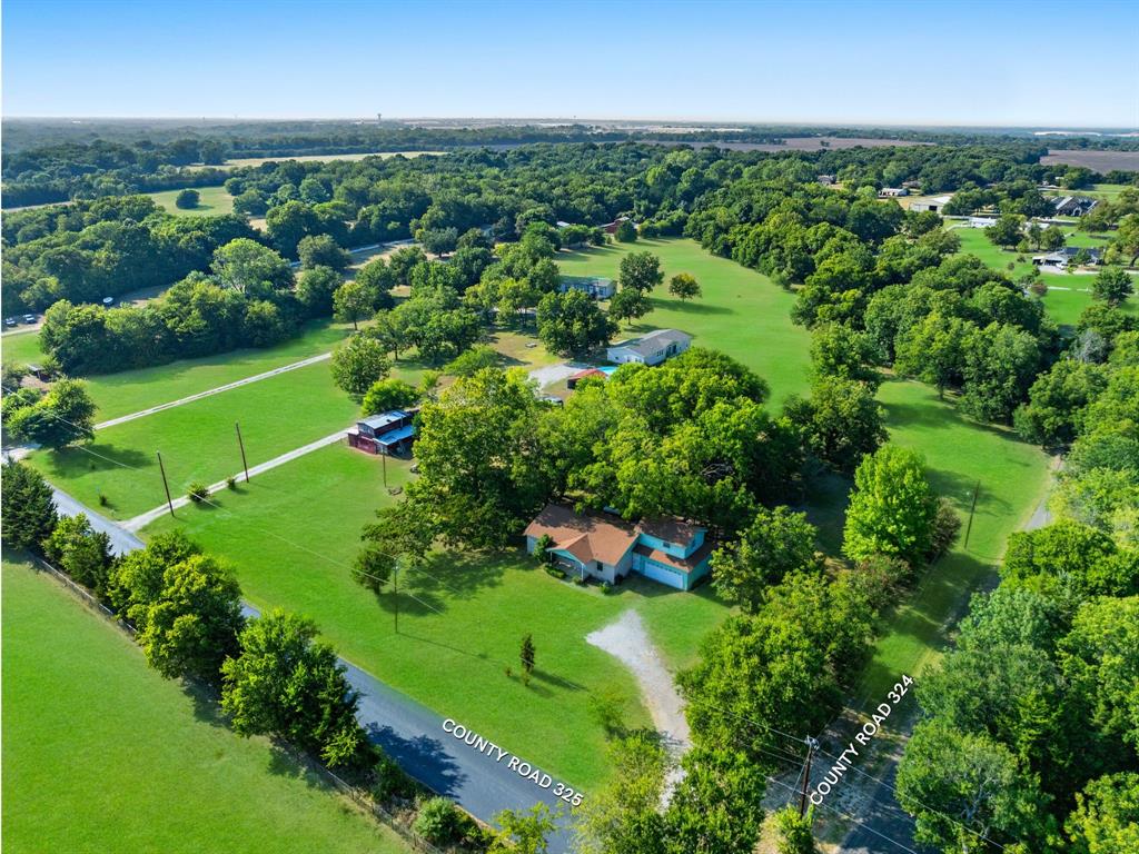 an aerial view of a houses with a yard