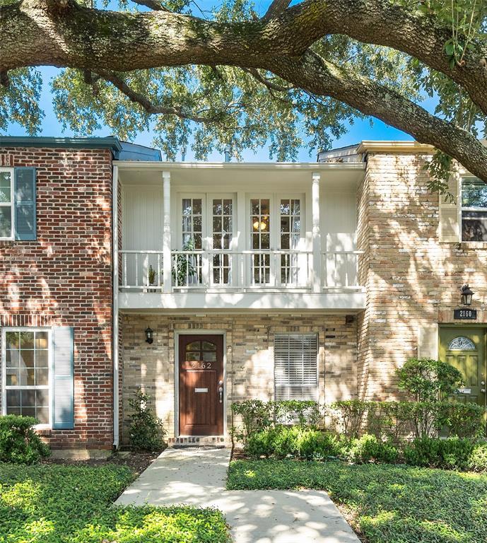 Welcome to 2162 Winrock Blvd, a charming townhome with attractive curb appeal, nestled on a manicured lawn surrounded by mature trees.