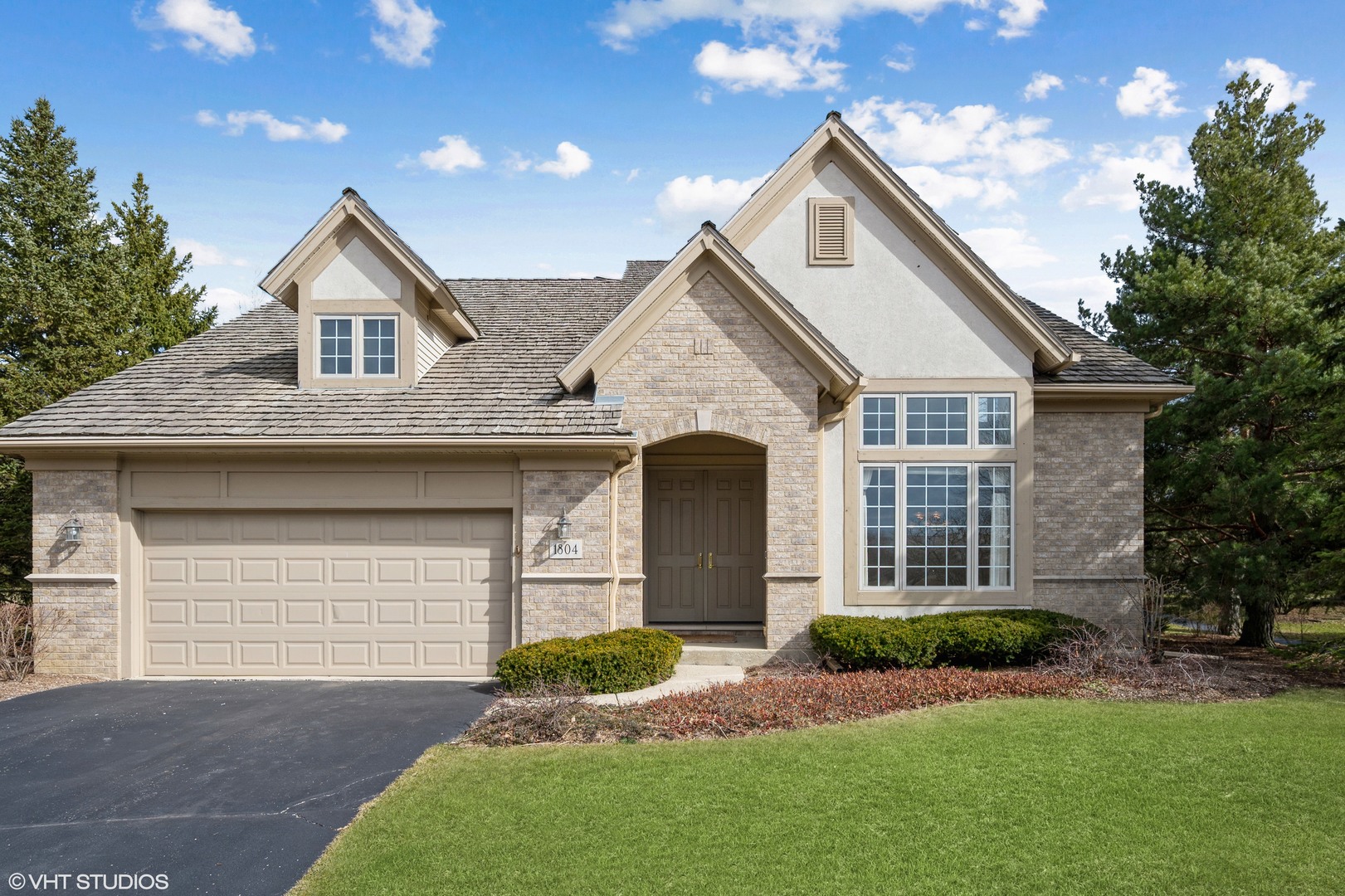 a front view of a house with a yard and garage