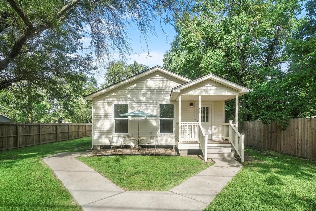 a front view of a house with a yard table and chairs