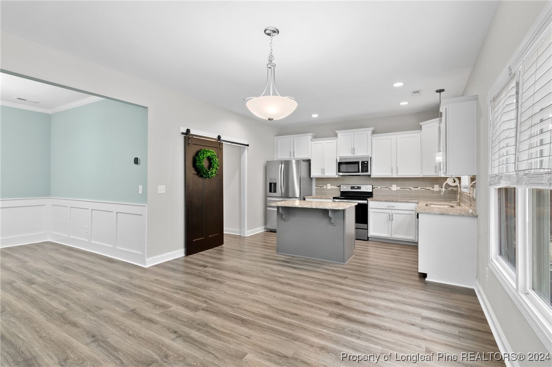 a view of kitchen with granite countertop cabinets and refrigerator