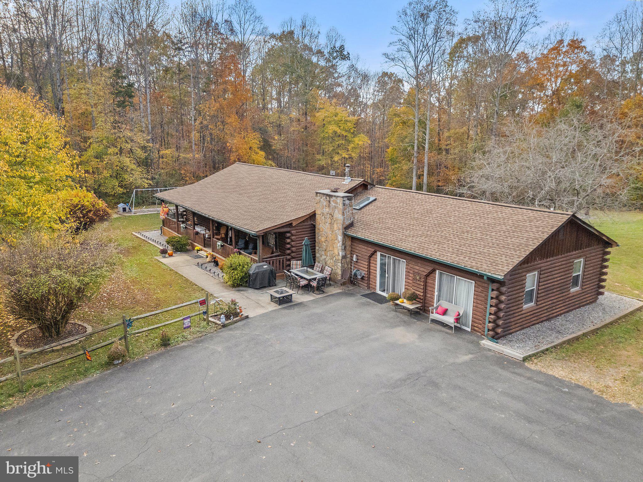 an aerial view of a house with table and chairs