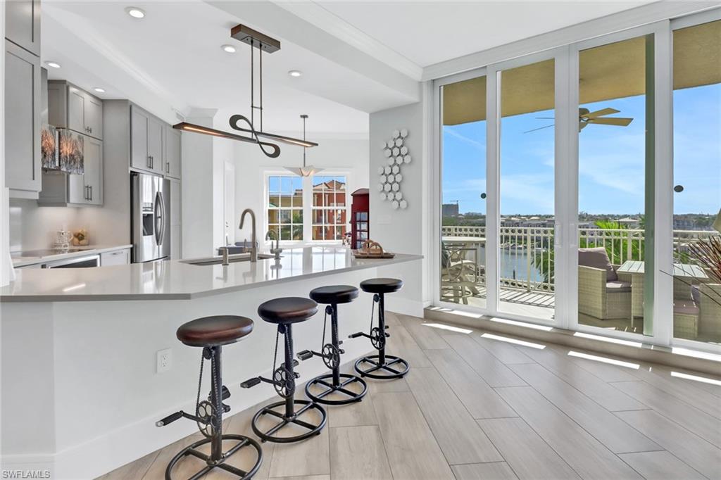 a view of a kitchen with kitchen island granite countertop a table and chairs