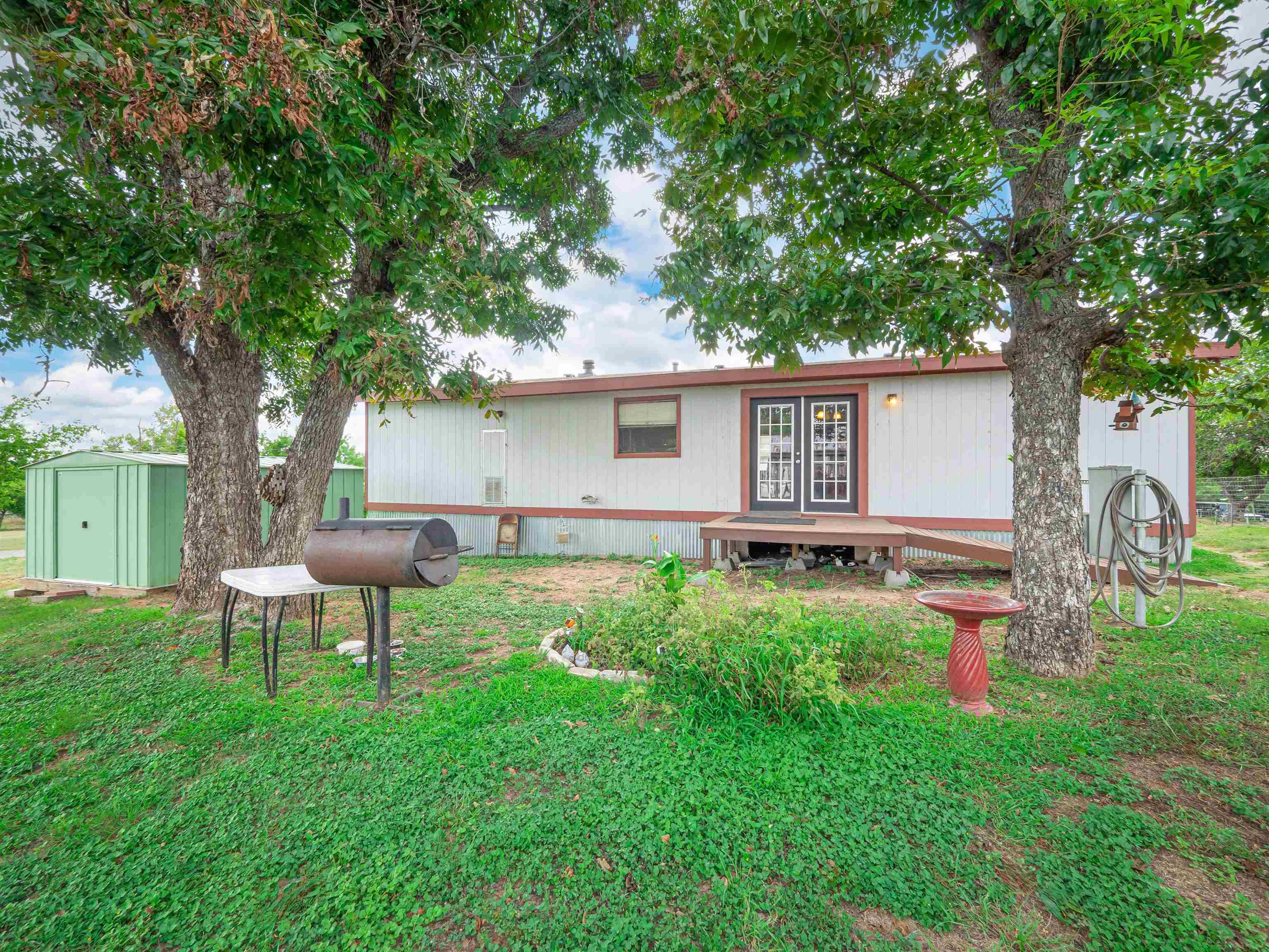 a backyard of a house with table and chairs