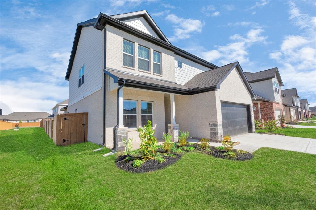 a front view of house with a garden and yard