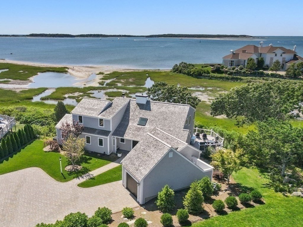 an aerial view of a house with garden space and lake view