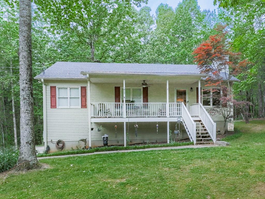 a view of an house with backyard space and balcony