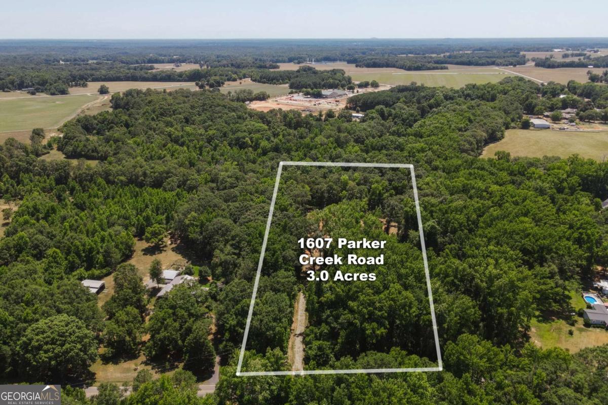 an aerial view of a house with a yard and lake view