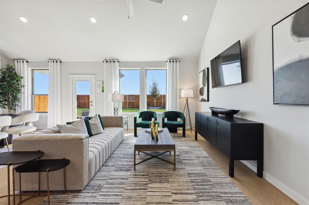 a living room with furniture and a wooden floor