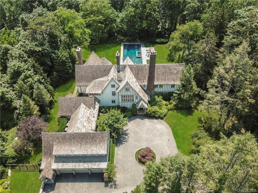 an aerial view of a house with outdoor space and a lake view