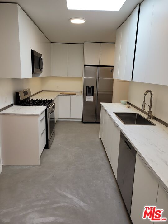 a kitchen with a sink stove and refrigerator