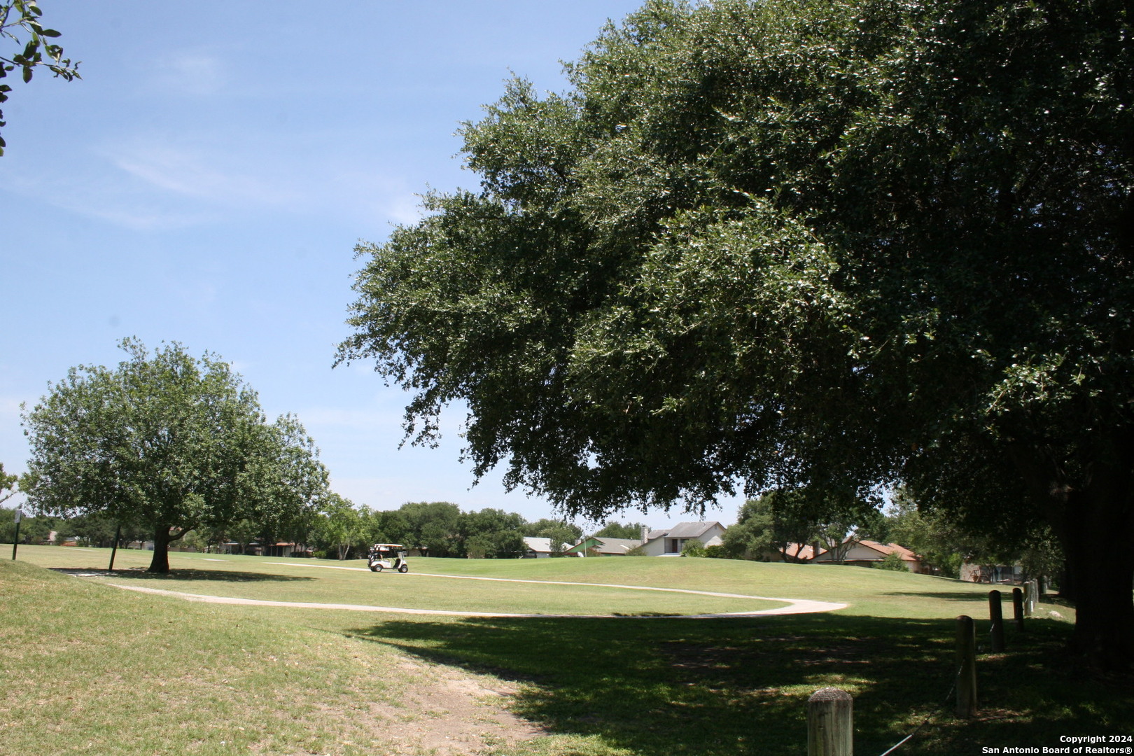 a view of a golf course with a lake view