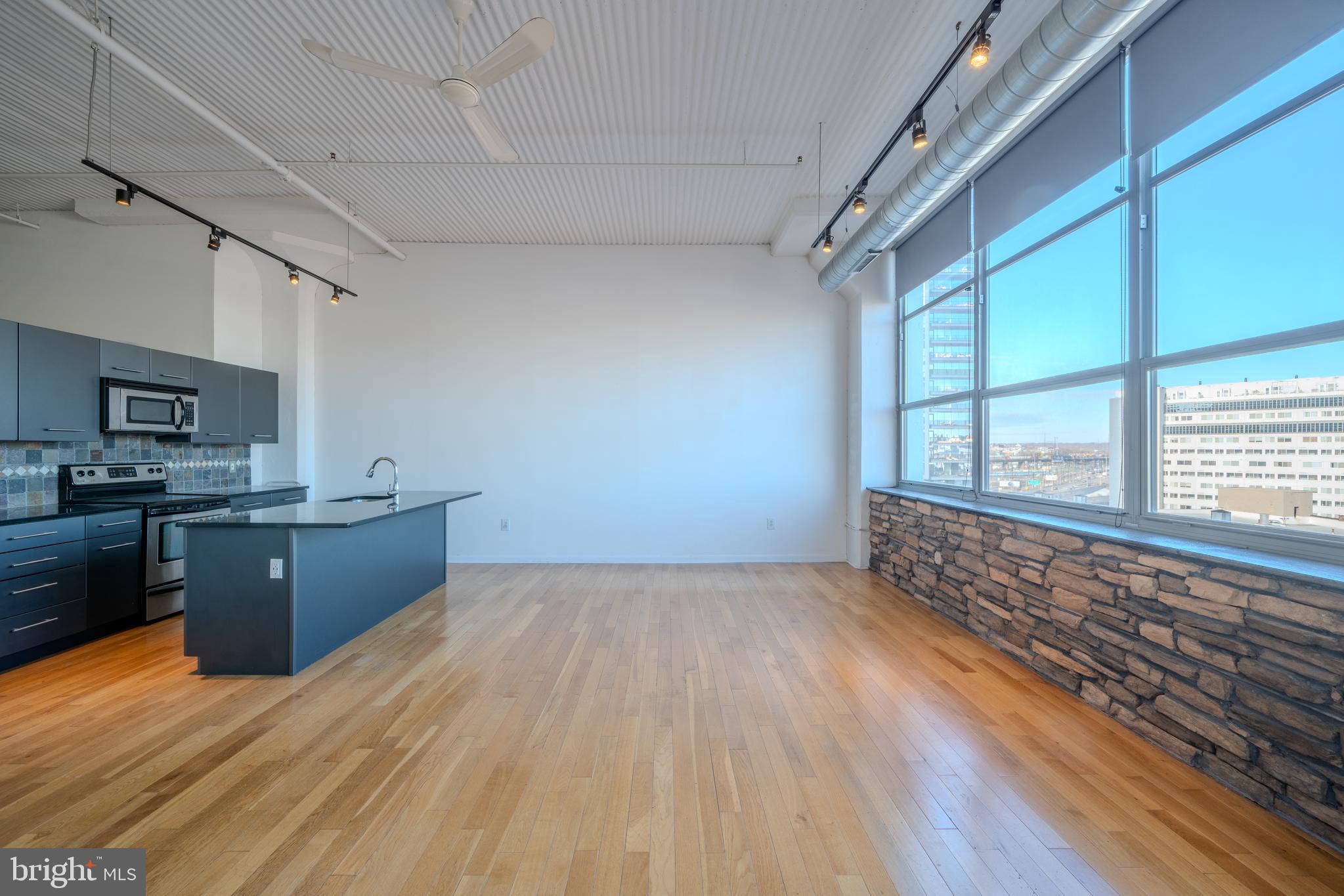 a large room with wooden floor and windows