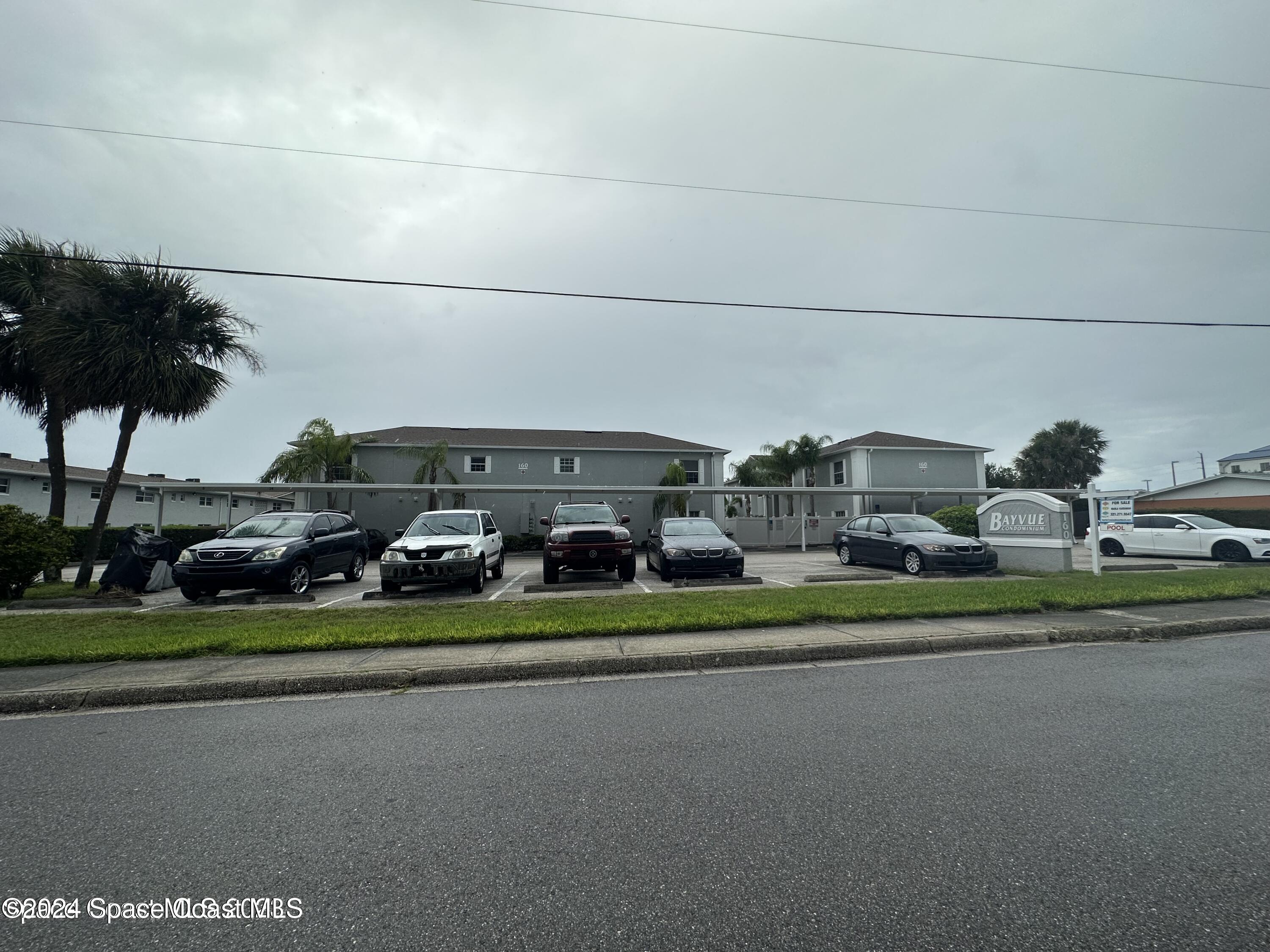 a couple of cars parked in front of a building