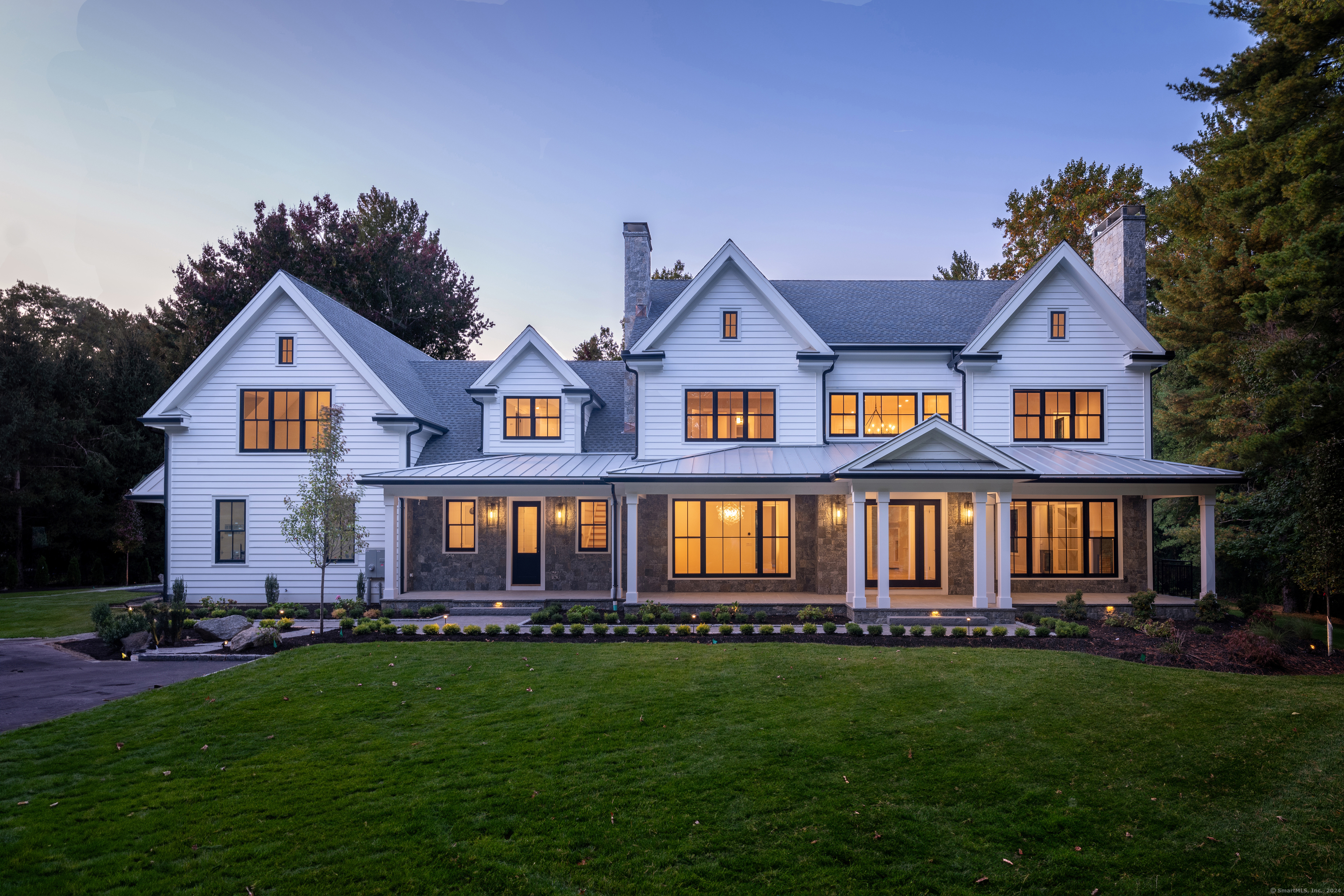 a front view of a house with a garden and porch