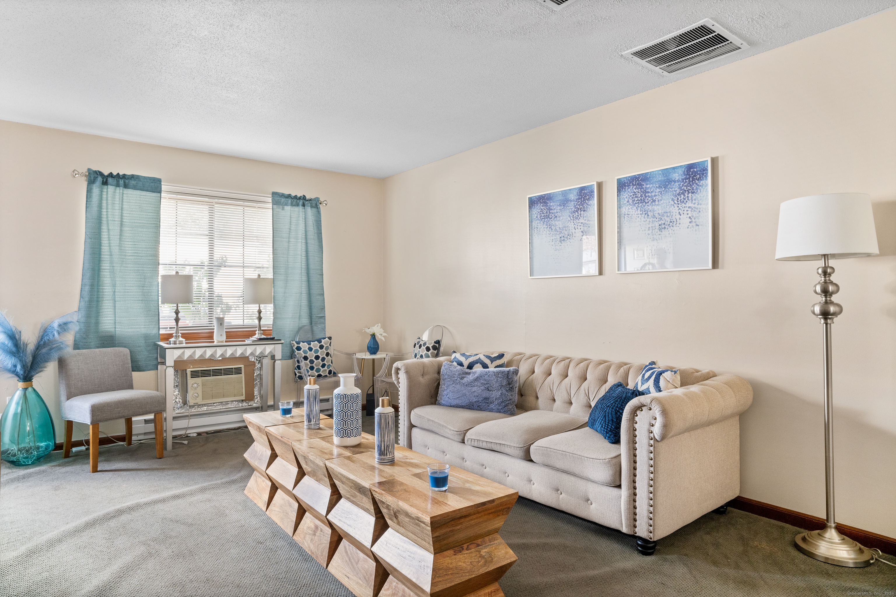 a living room with furniture and a large window