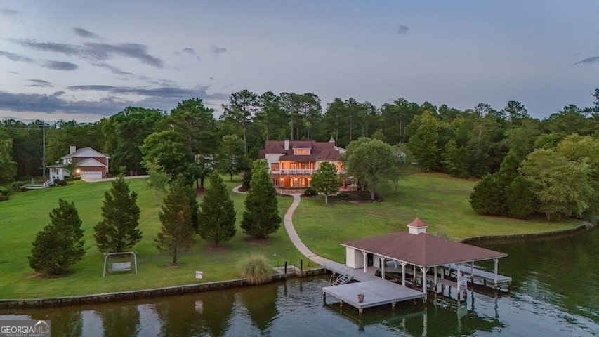 an aerial view of a house with swimming pool and outdoor seating