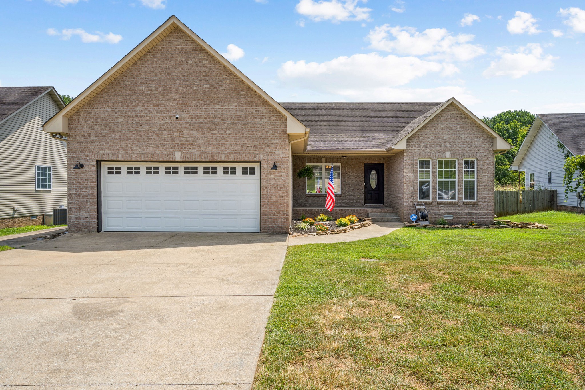 a front view of house with yard and outdoor seating