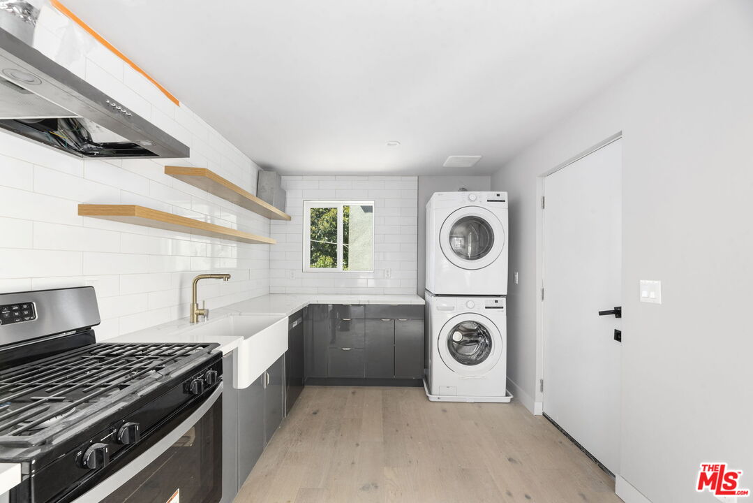 a utility room with sink dryer and washer