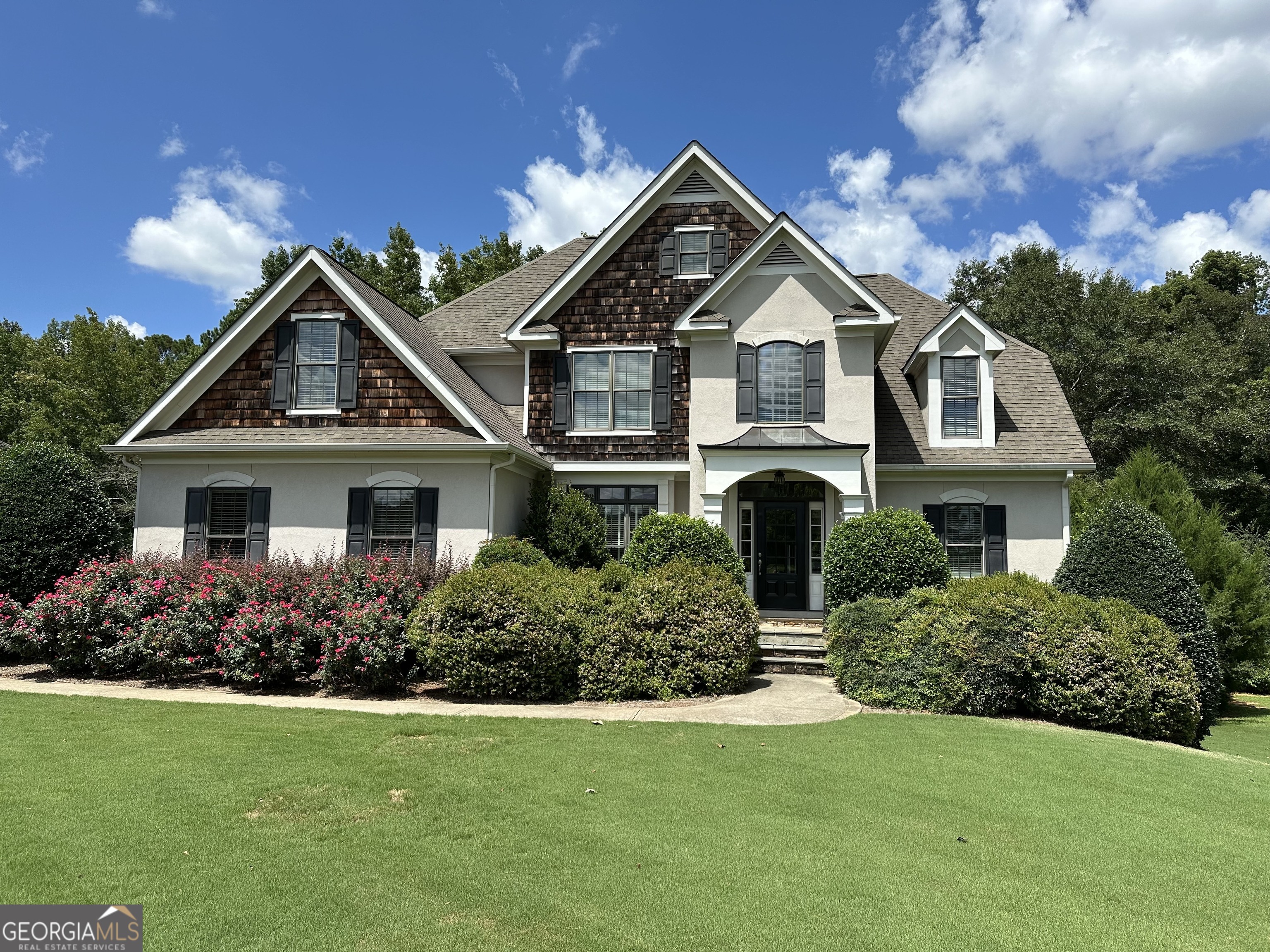 a front view of a house with a yard