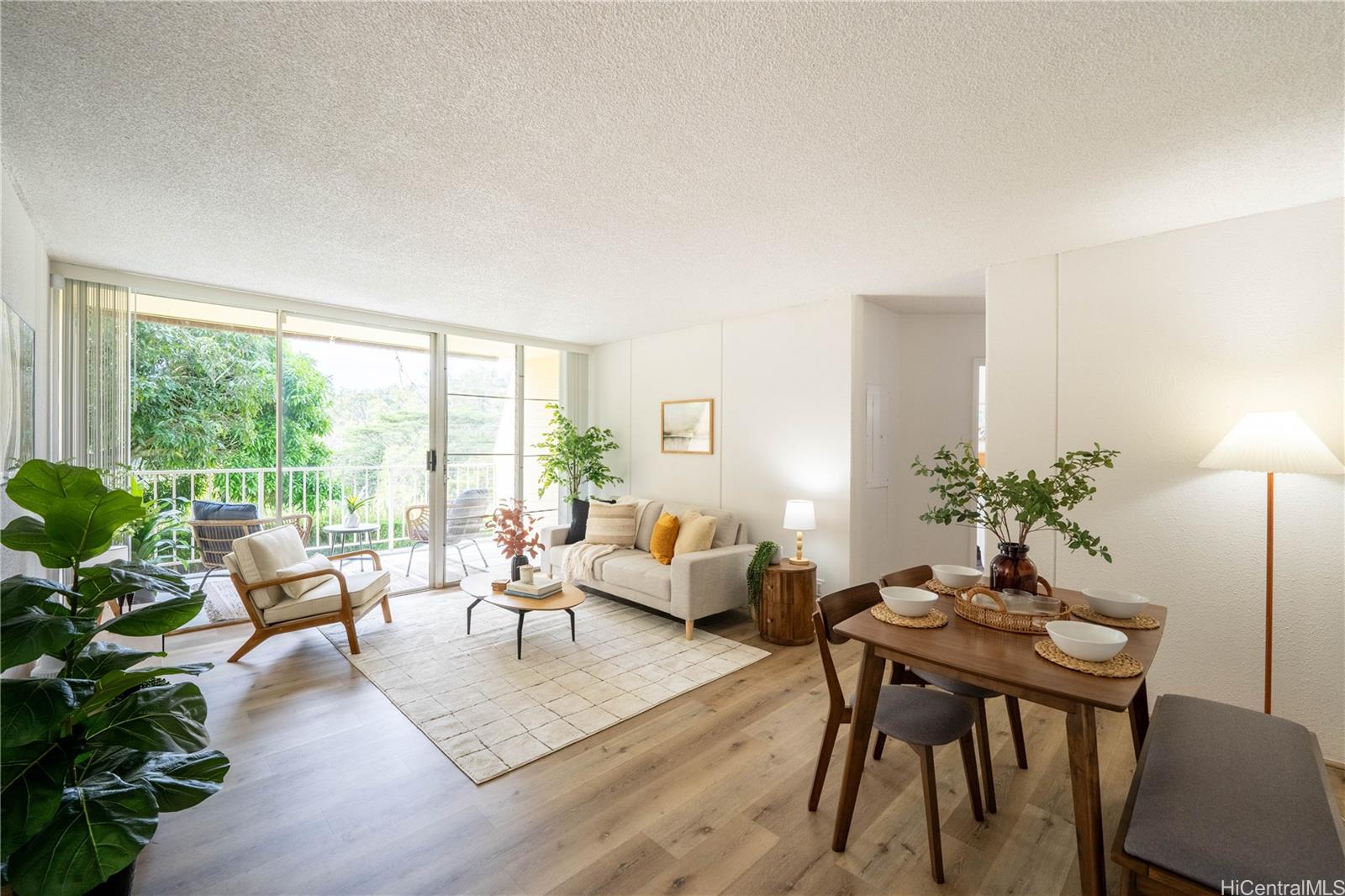 a living room with furniture potted plant a table and a potted plant