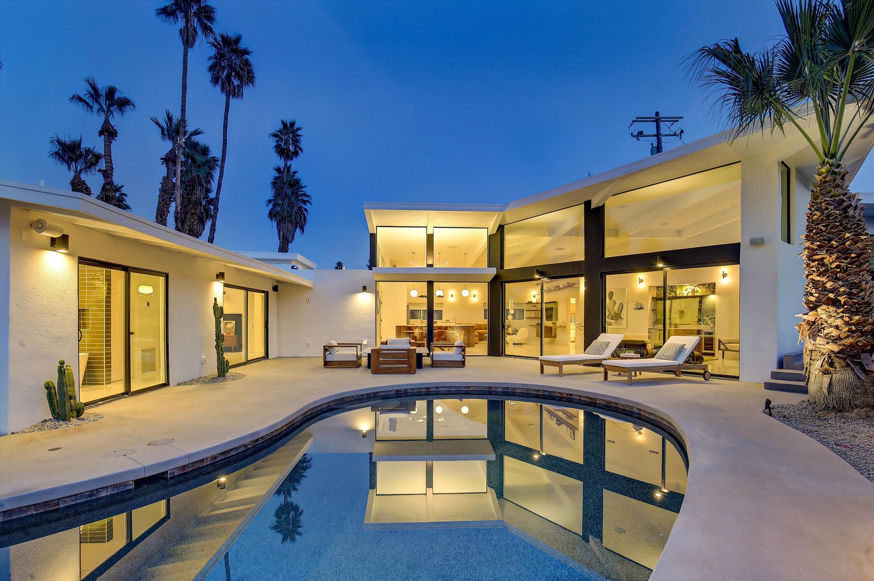 a view of a swimming pool with seating area