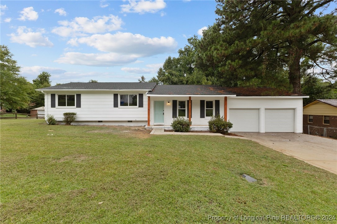 a front view of house with yard and trees