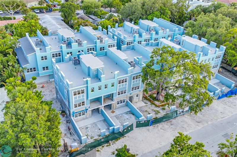 an aerial view of multiple houses with yard