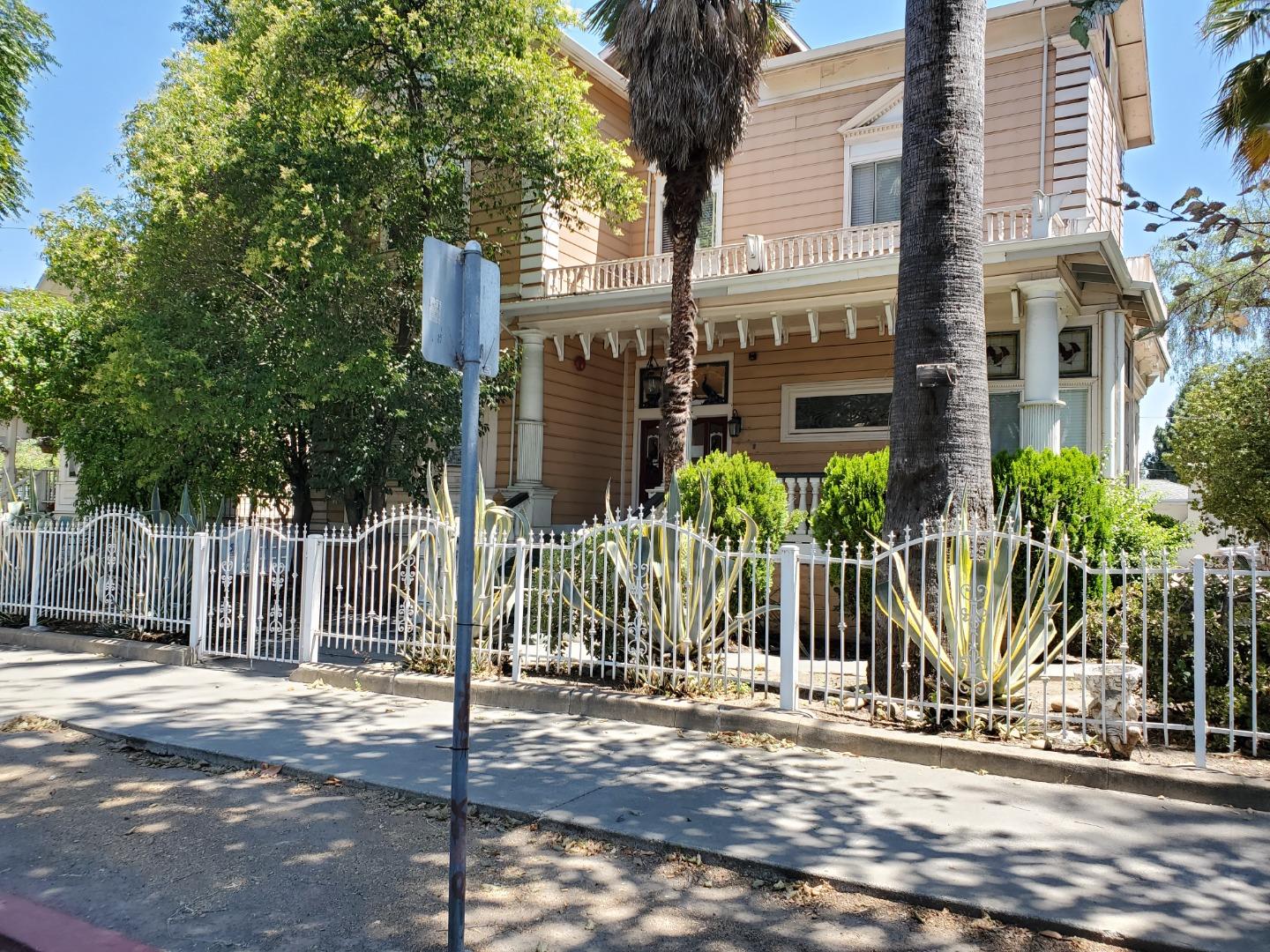 a view of a street with wooden fence