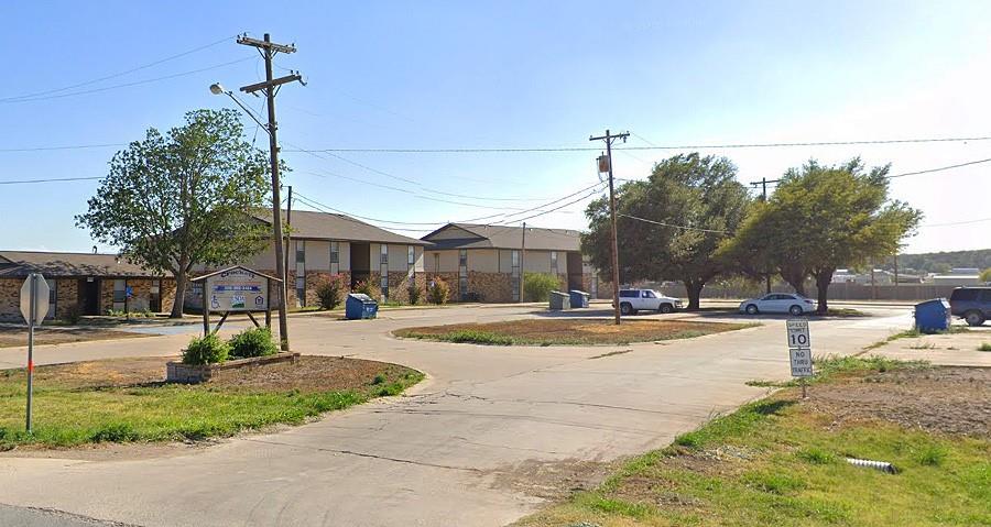 a view of a house with cars park