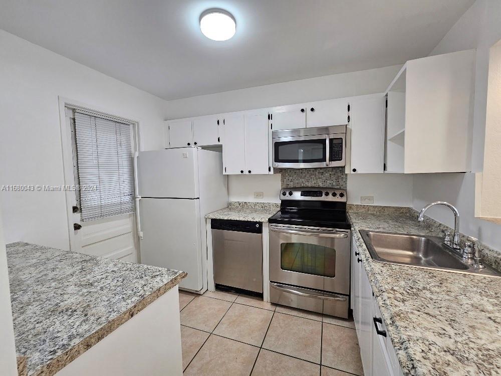 a kitchen with a sink stove and refrigerator