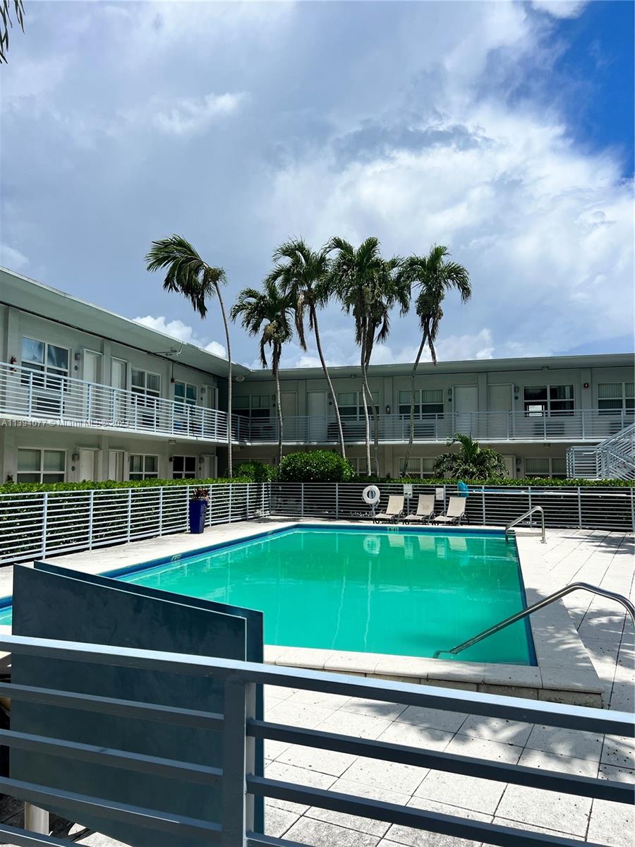 a view of a swimming pool with a garden and trees