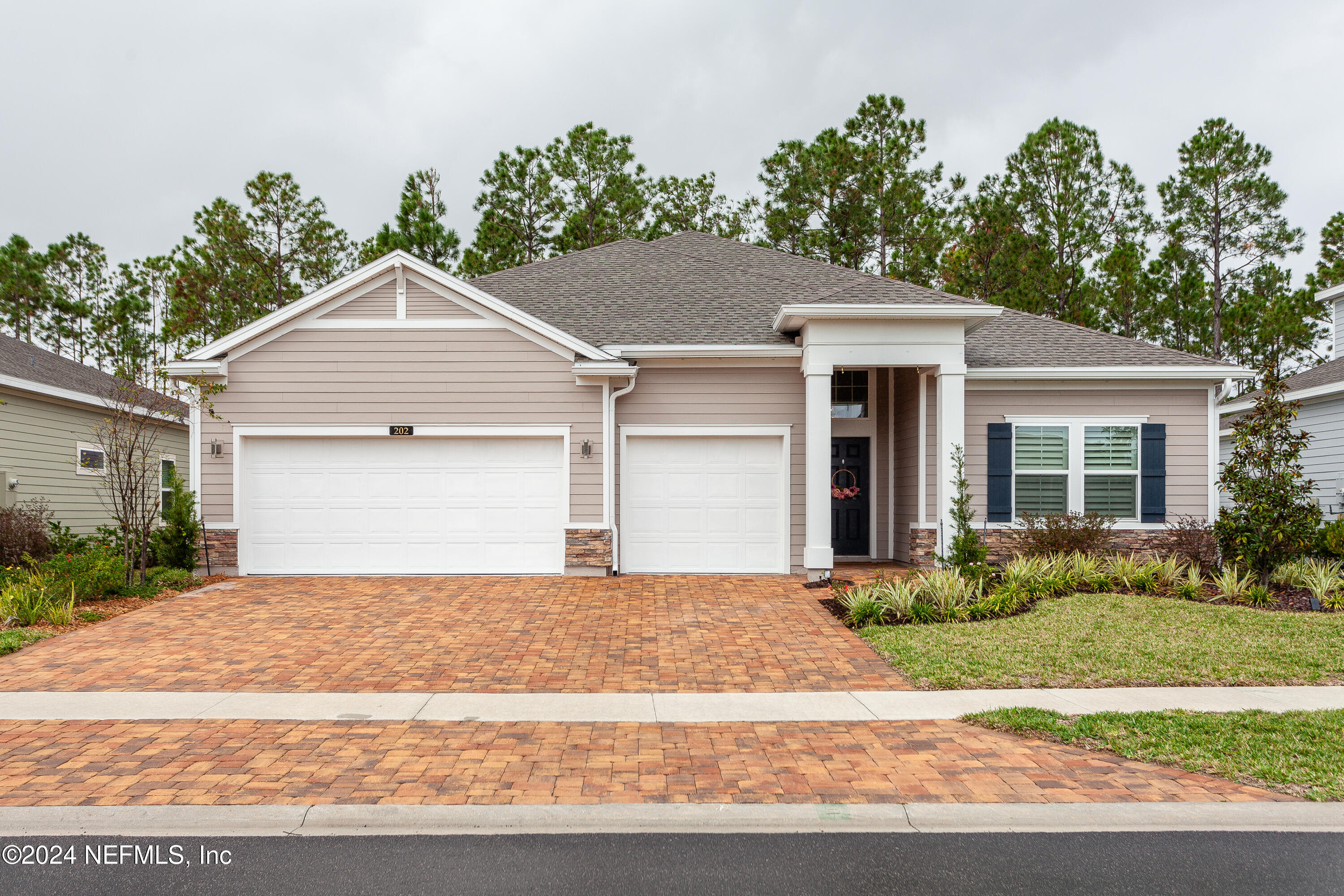 a front view of a house with a garden