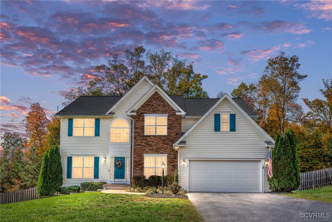 a front view of a house with a yard and garage