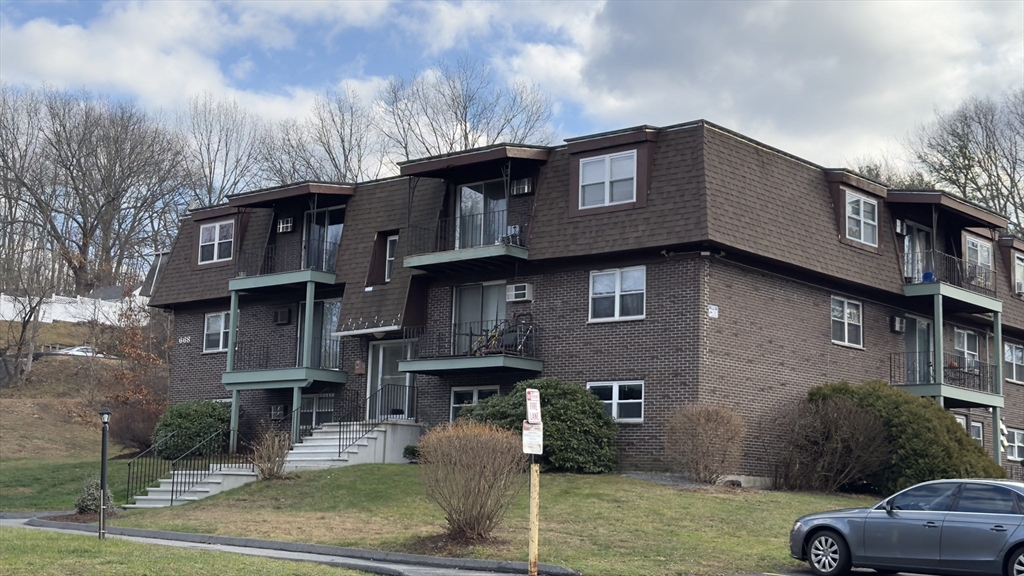 a front view of a house with parking space