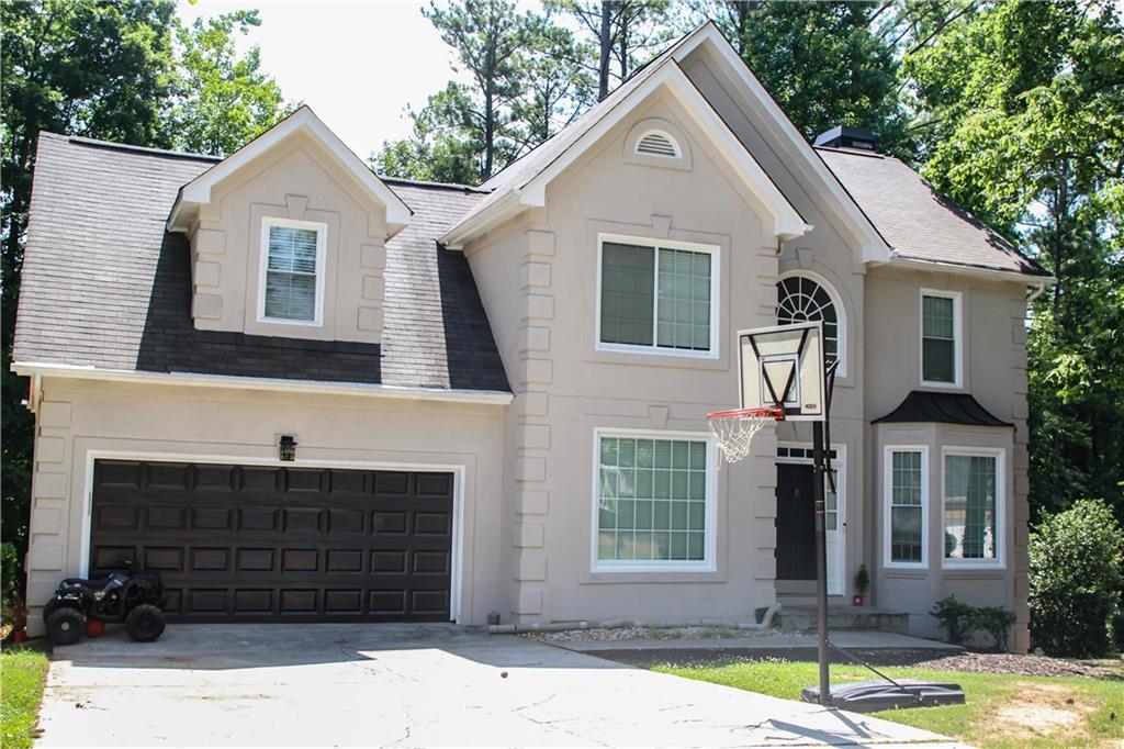 a front view of a house with a yard