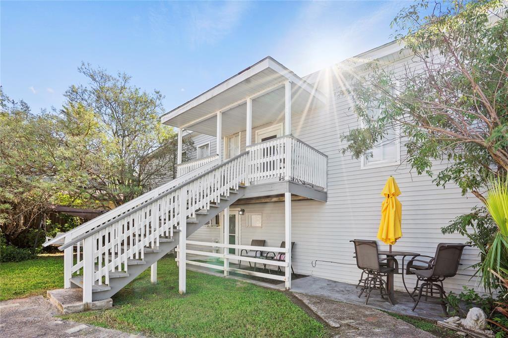 a view of a house with backyard and porch