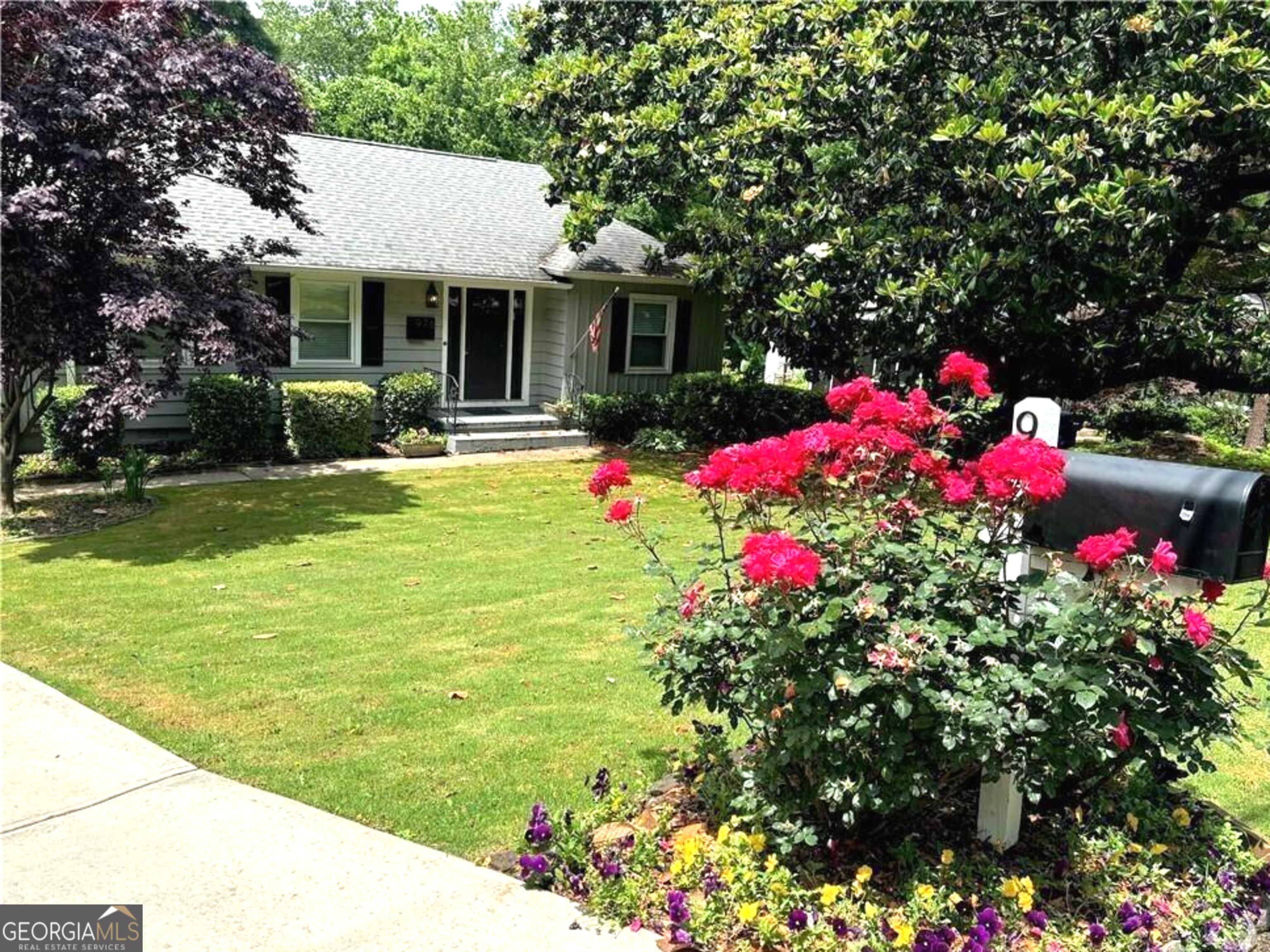 a front view of house with yard and flowers