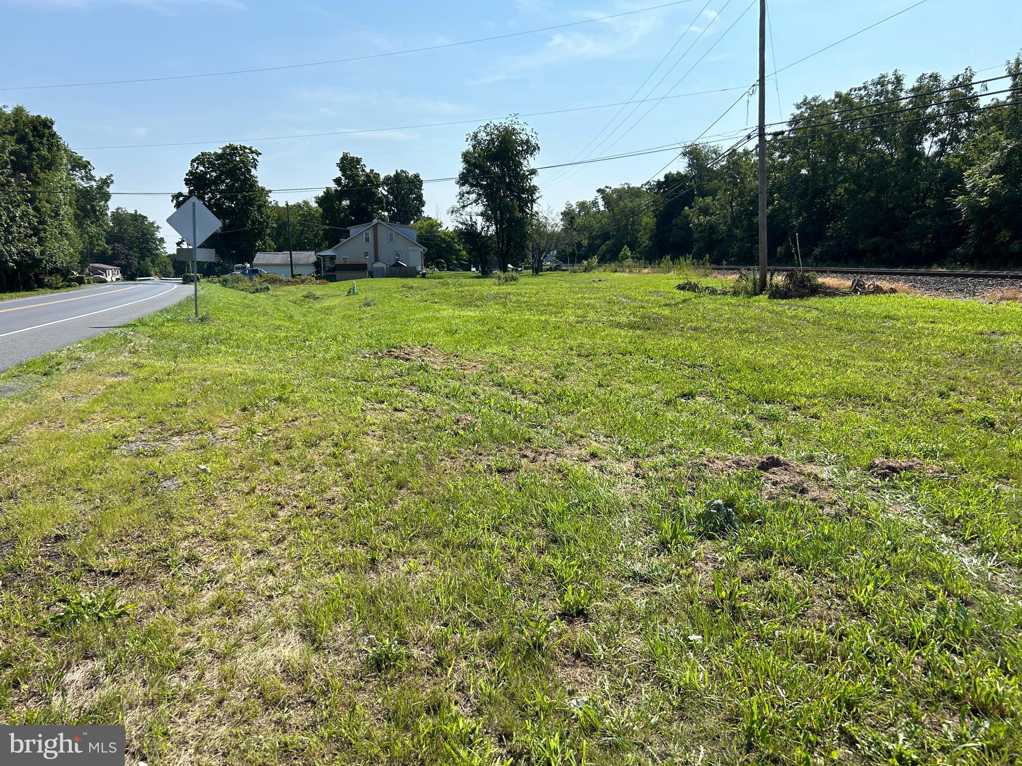 a view of a field with an trees in the background