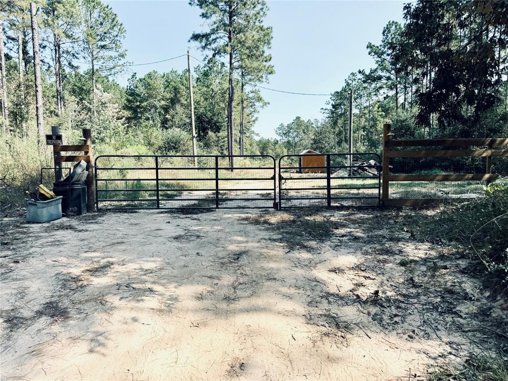 a view of a yard with wooden fence