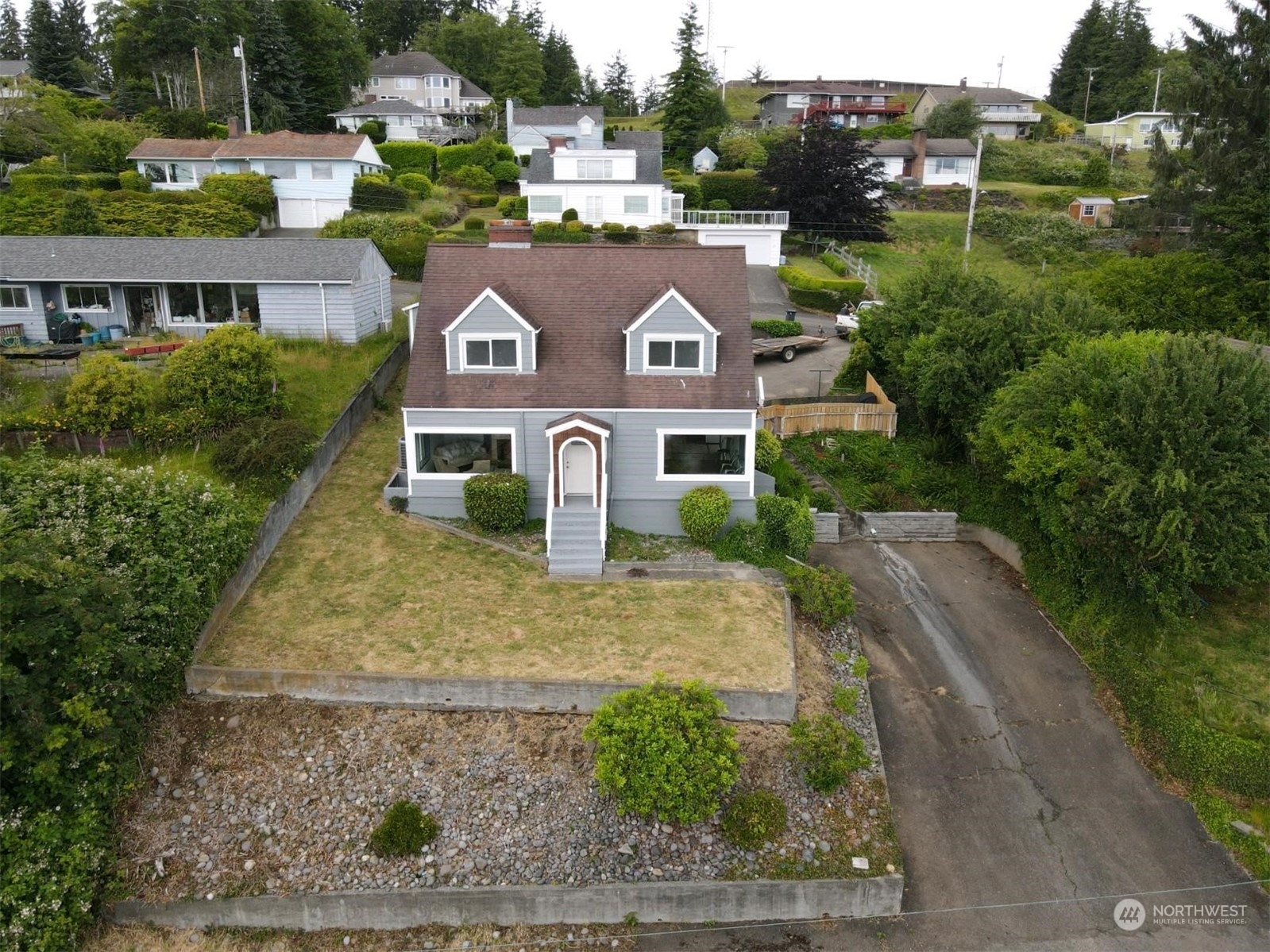 an aerial view of a house with a yard basket ball court and outdoor seating