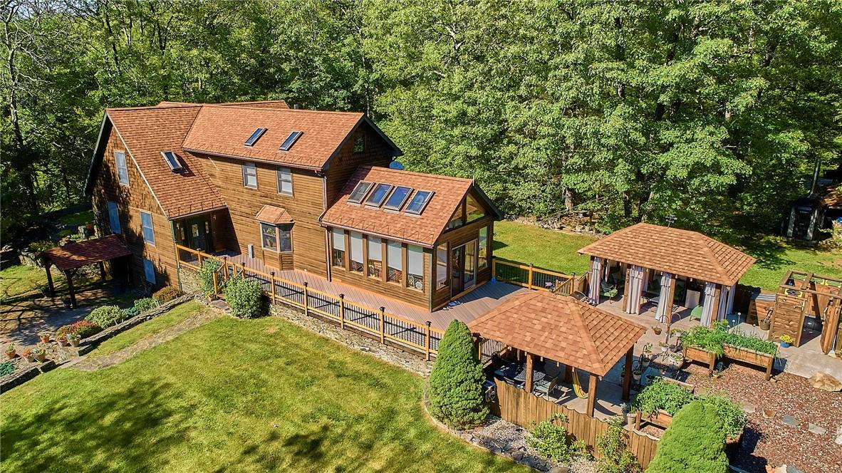 an aerial view of a house with swimming pool and porch