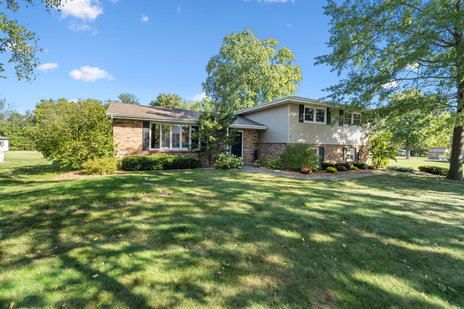 a front view of a house with a garden