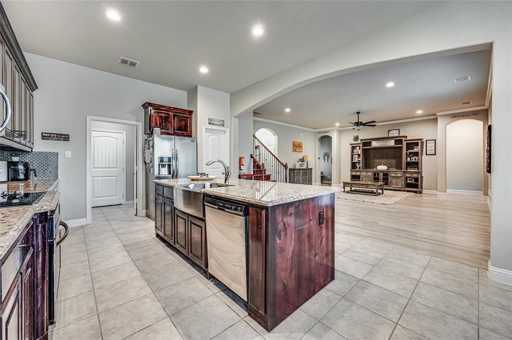 a kitchen with stainless steel appliances granite countertop a stove a sink and a refrigerator