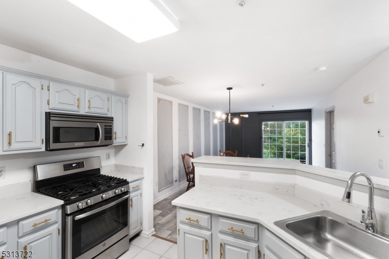 a kitchen with a stove a sink and a refrigerator