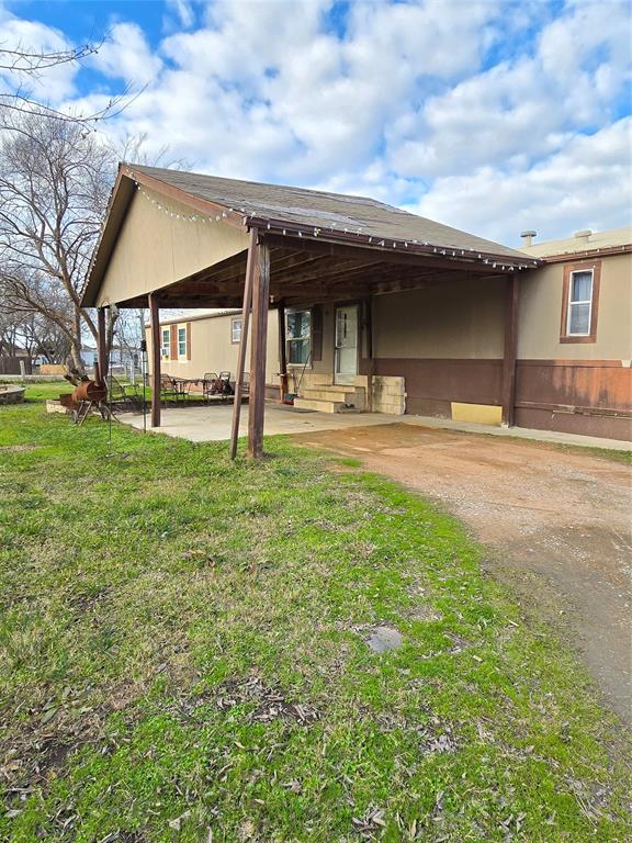 a view of a house with a yard and sitting area