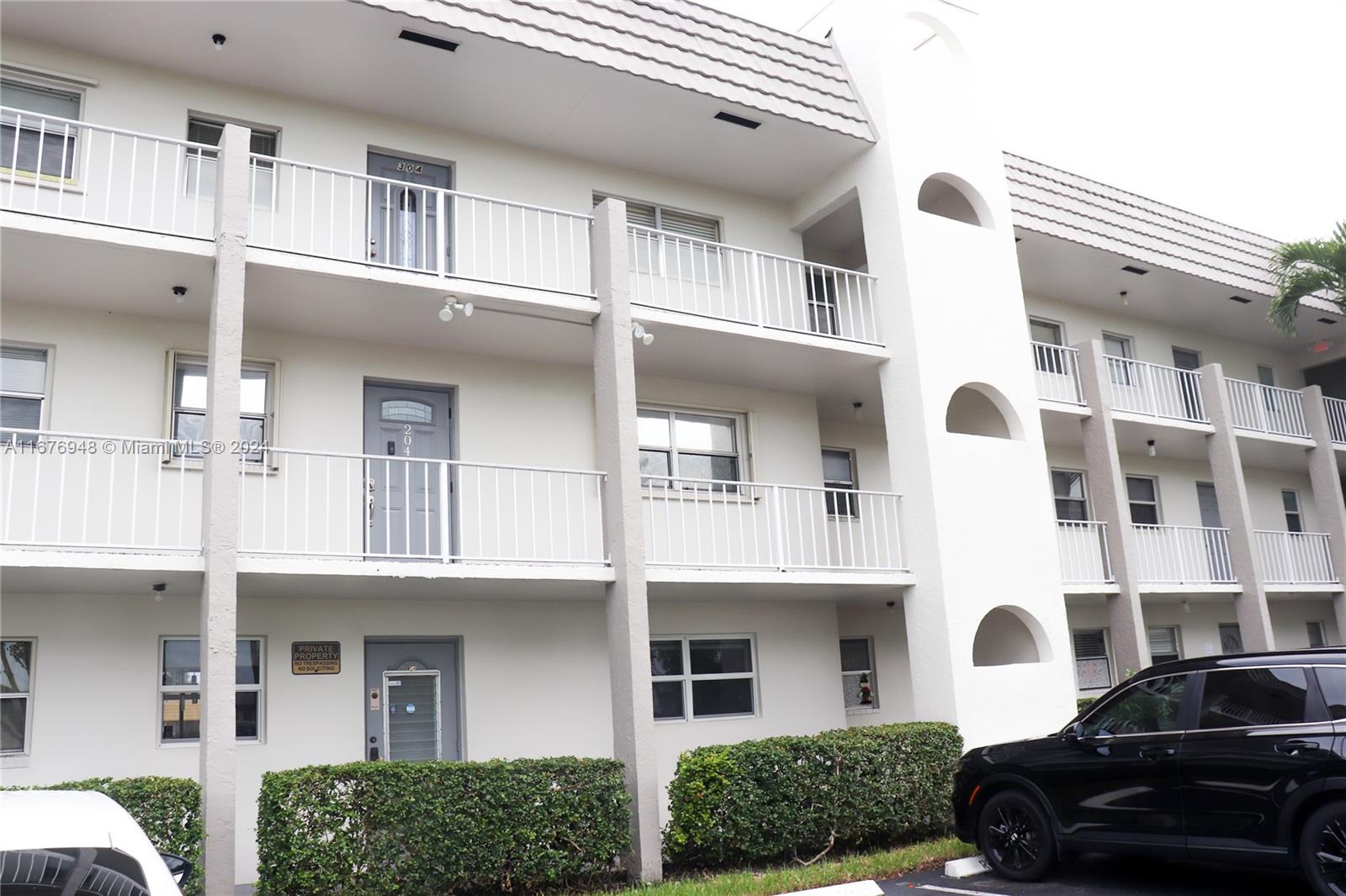 a front view of a building with parking space