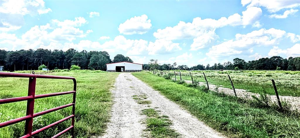 Welcome to your spacious country retreat, featuring a versatile red barn with ample storage and endless possibilities for customization.