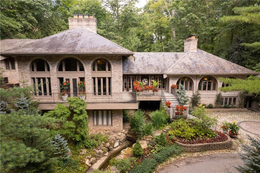 a front view of a house with a garden and plants